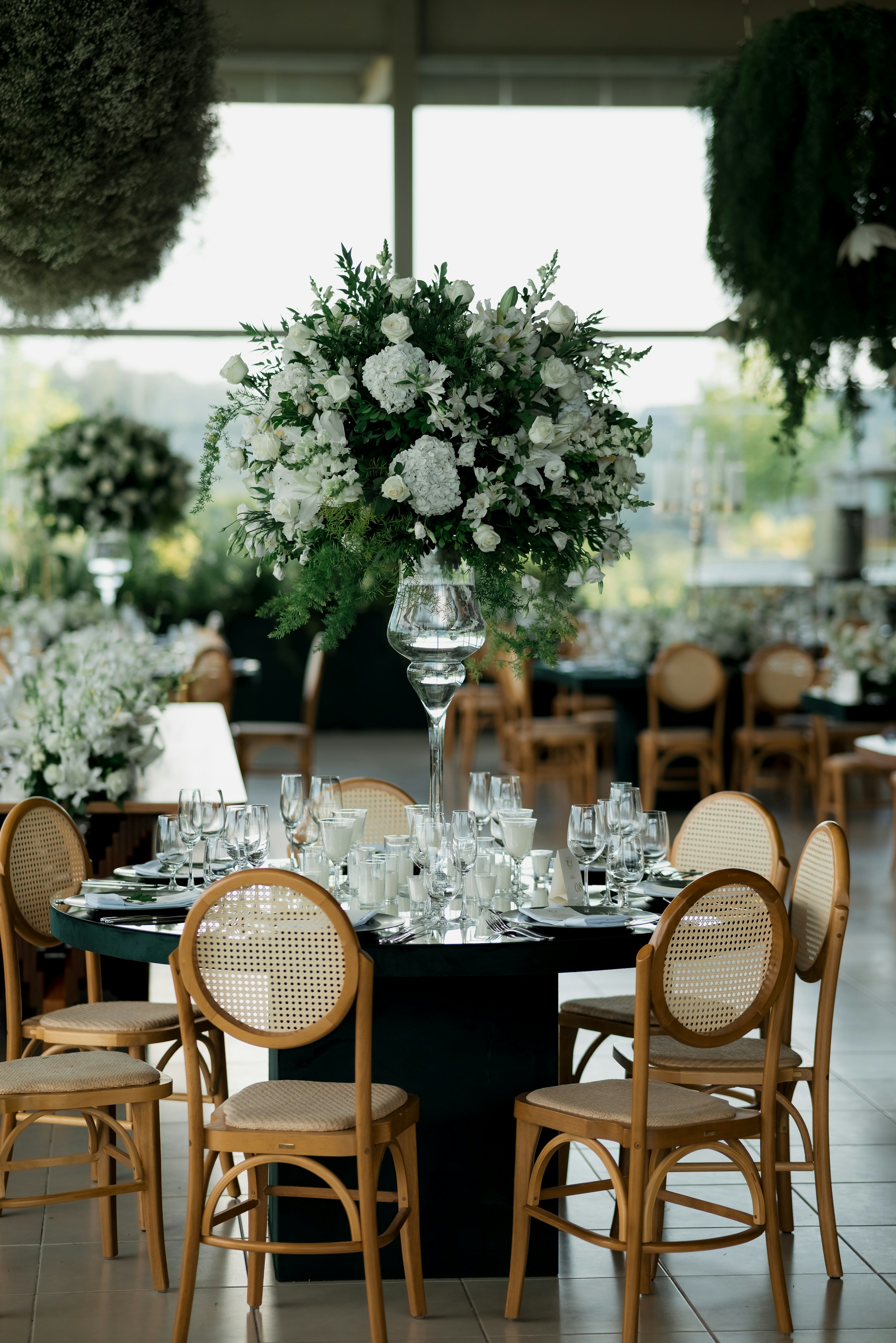 Real wedding reception with abundant white florals and elegant table settings